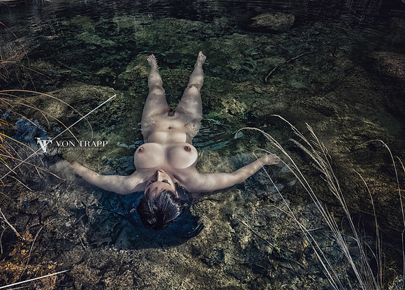 Art nude of a sexy woman laying in a Texas river.