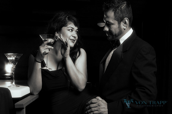 Emotive fashion photo of a couple in black tie having a cocktail.