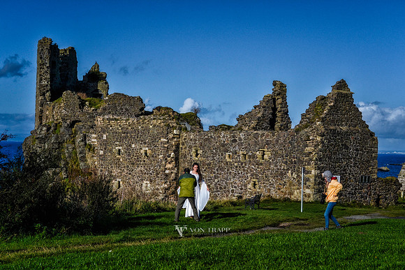 Behind the scenes photo od a photographer working with a model at Dunure Castle, Scotland.