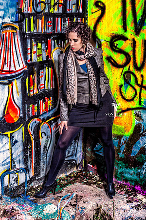 Fashion photo taken agenst a wall of graffiti.