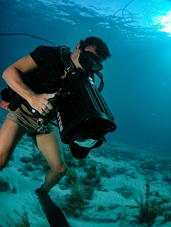 Underwater photo of a diver using a production quality video camera.