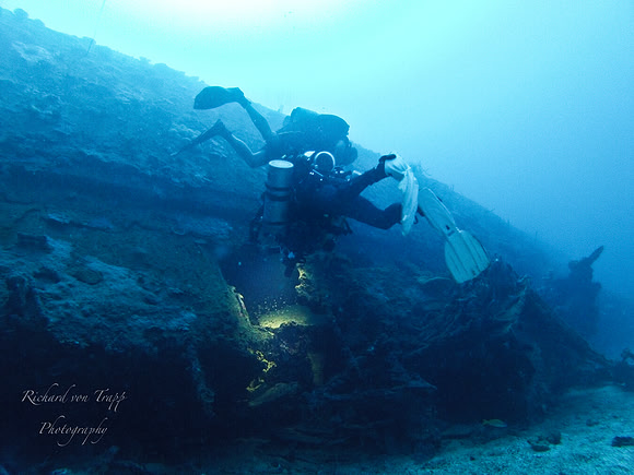 Underwater photo taken at 210 feet of two technical divers surveying a sunken Japanese Destroyer, Truk Lagoon, FSM.