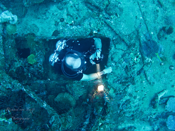 Underwater photo of a technical diver emerging from a sunken Japanese Destroyer at 195 feet in Truk Lagoon, FSM.
