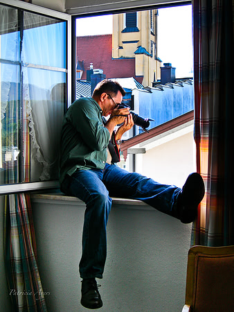 Photographer photographing from a window in Bad Toelz, Germany.