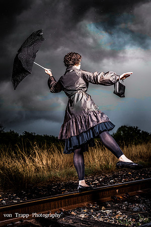 Art photo od a woman on rail road tracks in the rain. Evocative Glamour Photograph by Austin/San Antonio/Houston/Dallas Glamour Photographer Richard von Trapp. Glamour Photography. Boudoir Photography
