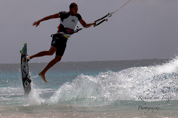 Kite surfer making a jump into the air.