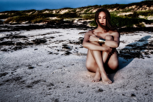 Color Fine Art Nude photo of a sexy woman sitting on a Texas beach.