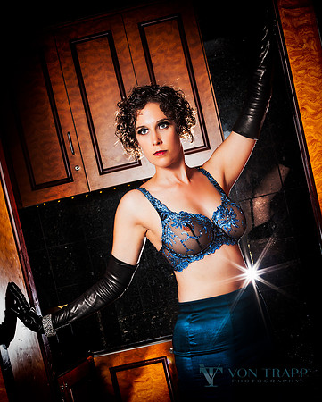 Lingerie glamour photo of a sexy woman in a sheer blue bra.