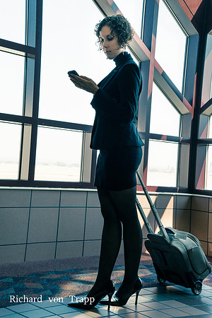Young woman at the airport checking her messages.