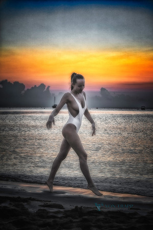 Fine art photo of woman on beach at sunrise