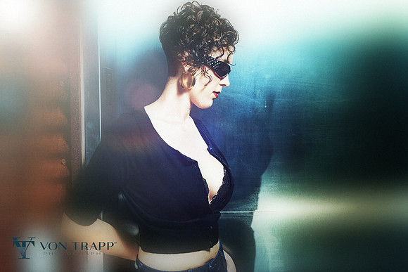 Emotive and edgy photo of a busty woman in a tight cropped sweater.