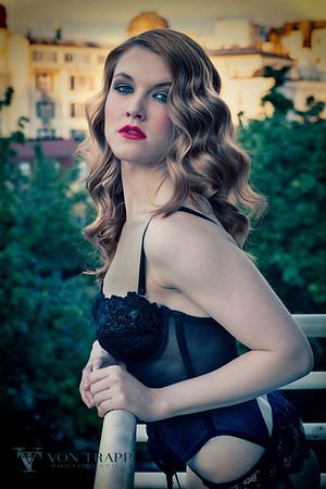 Fashion photo of model on a Prague balcony in lingerie.