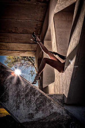 Fashion nude photo of a woman legs, wearing tall sexy heels under a bridge in New Braunfels, TX.