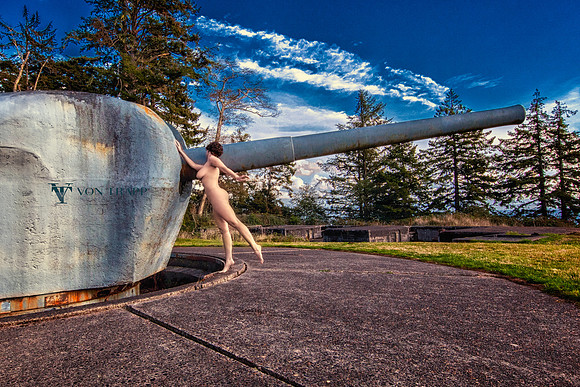 Art nude photo of a woman posed next to a costal-defiance gun at Fort Columbia, WA.