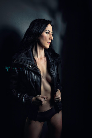 Sexy Fashion-Glamour photo of a braless woman wearing a black leather jacket and panties.