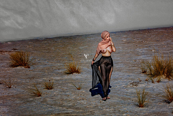 Fine art nude photograph of a woman in a gauze skirt and head scarf, walking topless in the desert at White Sands, N.M.