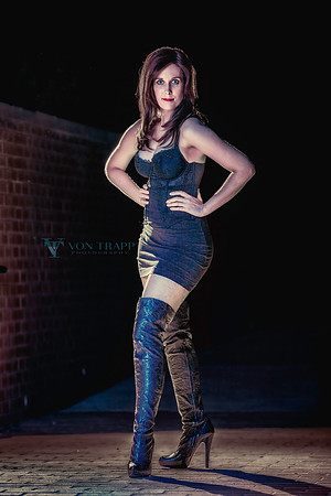 Sexy photo of a hot redhead in a mini skirt, bustier, fishnets and thigh-high fuck me boots.