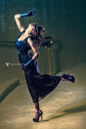Nighttime fashion shoot in San Antonio showing a sexy woman in a long gown, opera gloves, and stilettoes.