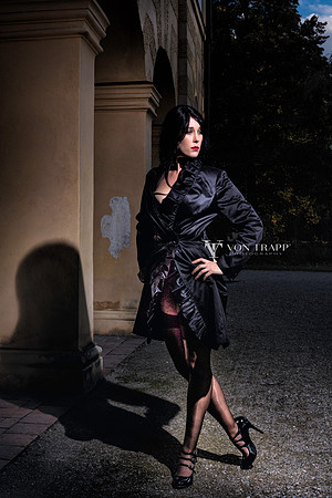 Photo of a tantalizing woman in stocking and a black trench coat flashing in Germany.