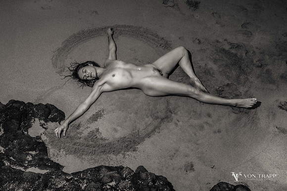 Female nude on a beach.
