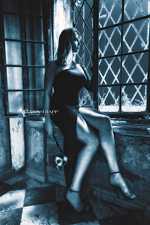 Glamou photo of a leggy woman in a thigh-high cut gown and heels on a street in Venice Italy.