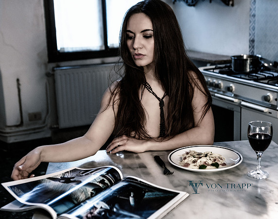 Fashion nude of a woman in a Venice palazzo kitchen, topless.