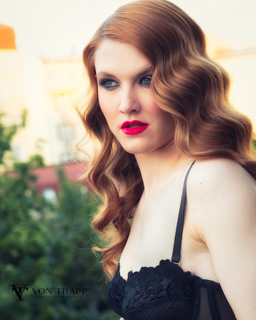 Lingerie glamour photo of a woman on a Prague balcony.
