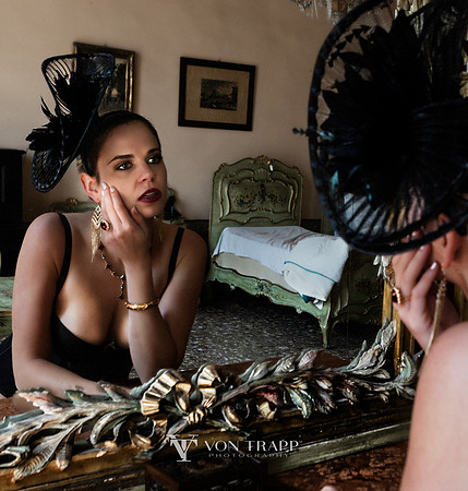Emotive image of a woman looking into a mirror in a Venetian palazzo.