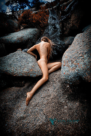Art nude photo of a woman among huge stones at Enchanted Rock State Park.