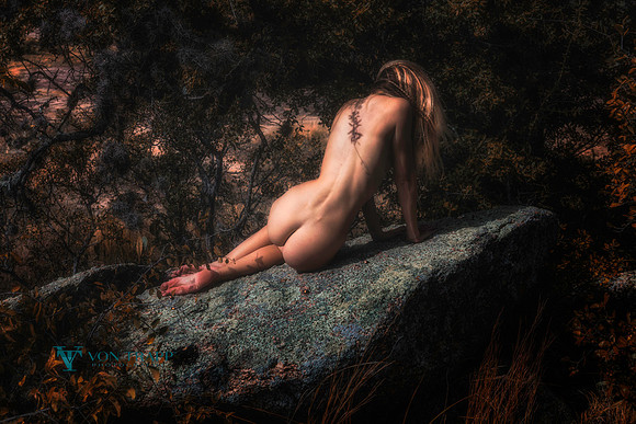 Art nude photo of a woman among huge stones at Enchanted Rock State Park.