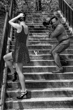BTS image of a photographer photographing a model in Prague.