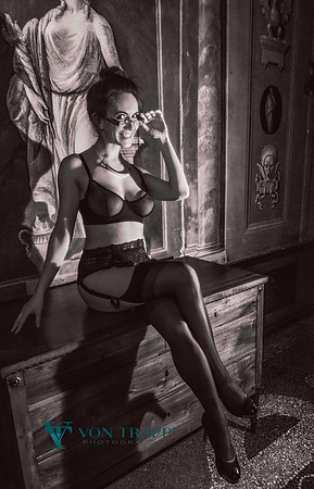 Fashion glamour image of a woman in a Venice palazzo wearing lingerie.