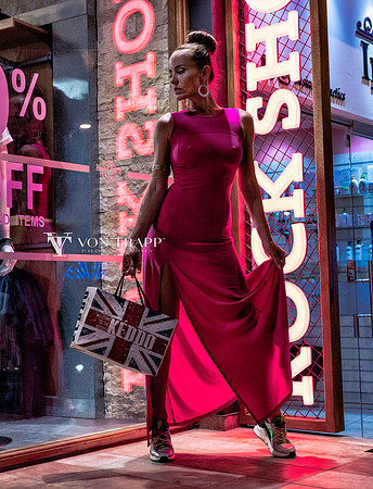 Sexy photo of a woman on a street in Cyprus at night in a tight-revealing dress.