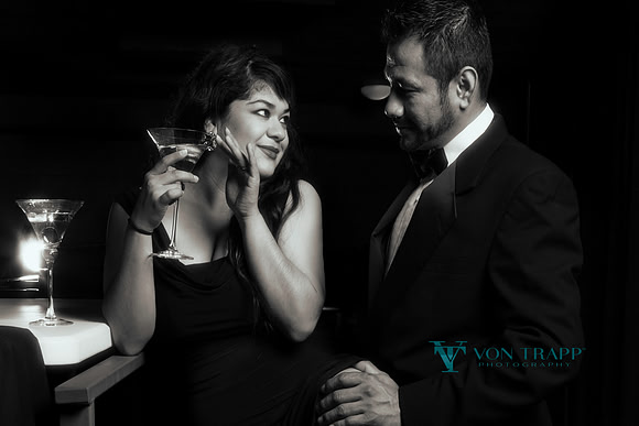 Photo of a well dressed couple in a cocktail bar.