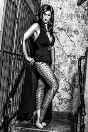 Sexy fashion-Glamour photo of a woman in a long gown with a hip-high slit, flashing lots of leg.