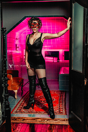 Erotic photo of a hot woman in a mask and lingerie.