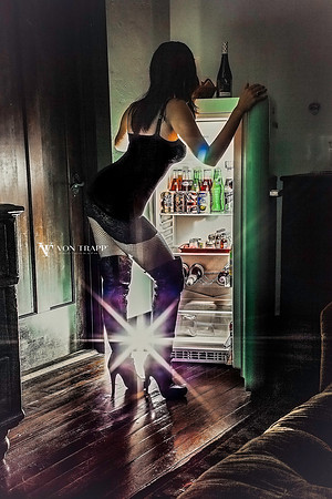 Boudoir-Glamour photo of a hot woman in lingerie looking into a refrigerator.