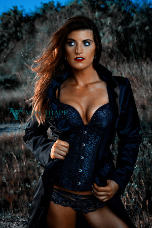 Photograph of a woman wearing a corset and panty outdoors.