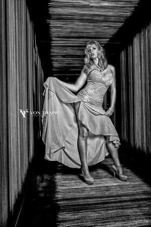 Fashion glamour photo of a hot blonde in a high-slit gown.