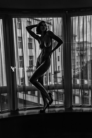 B&W art nude photo of a 6 foot tall Czech beauty posed in a window.