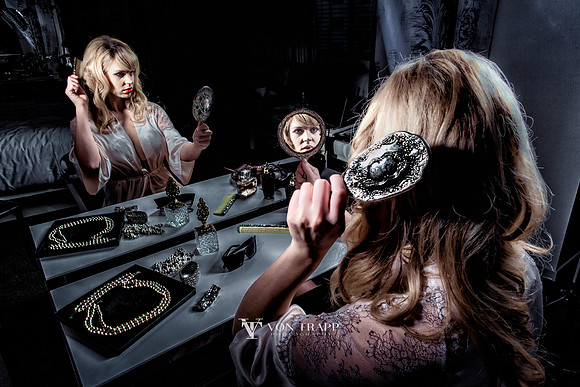 Lovely boudoir photograph of a hot blonde sitting at her make-up table.