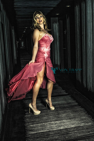 Sexy photo of a woman wearing a long gown with a high skit hem flashing leg.