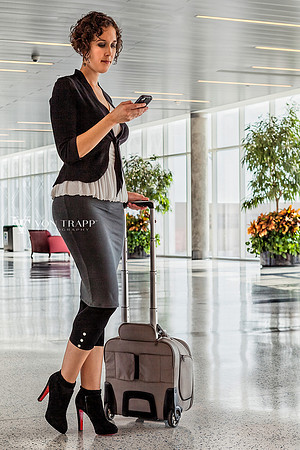 Photo of a stylish and sexy female traveler in an airport.