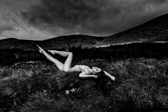 Art nude photo of a busty-leggy beauty in a mountain pasture in the Lake District of England.