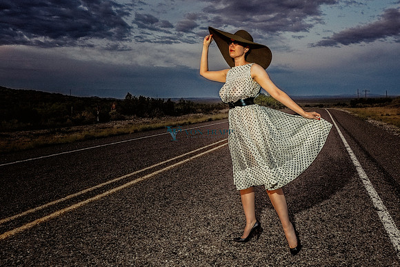 Fashion-Glamour photo of a hot woman in a sheer dress , posed on a road in New Mexico