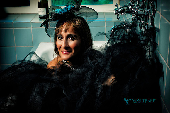 Photo of a beautiful woman dressed in a tulle skirt and fascinator.