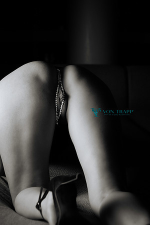 Erotic art nude photo of a woman wearing a pearl thong.