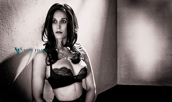 Lingerie photo of a busty woman in a lace bra.