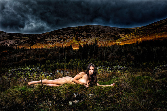 Art nude photo of a hot woman laying in a English field in the Lake District.