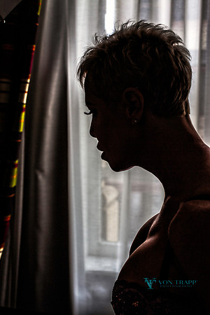 Emotive silhouette portrait of a busty mature woman.